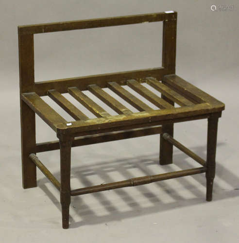 An early 20th century oak luggage rack, on turned legs united by stretchers, height 76cm, width