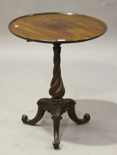 An early Victorian mahogany circular wine table, raised on a twisted column and tripod scroll