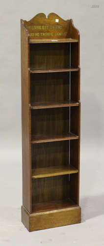 An Edwardian mahogany narrow open bookcase, the gallery inscribed in gilt 'Un livre est un ami qui