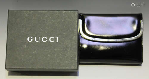 A Gucci black patent leather purse with plated clasp, width 13.2cm, together with original