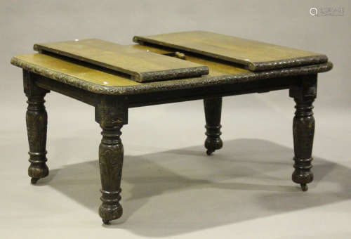 A late Victorian carved oak extending dining table with two extra leaves, height 71cm, extended