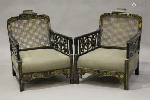 A George V ebonized and chinoiserie decorated three-piece bergère suite, the cane backs above