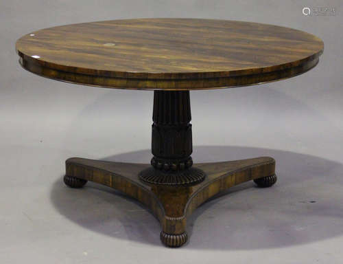 A Regency rosewood circular tip-top breakfast table, raised on a reeded and carved palmette