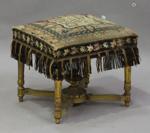 A 19th century Louis XVI style giltwood footstool with a period polychrome silkwork seat, raised
