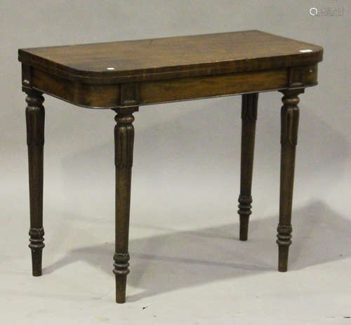 A William IV mahogany fold-over card table, raised on turned and tulip cusp tapering legs, height