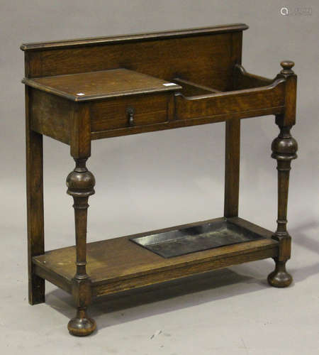 A George V oak hallstand, fitted with a single drawer and a two-division stick stand, on turned legs