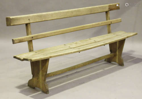 A mid-20th century wooden slatted bench, on shaped supports, height 87cm, length 205cm, depth 40cm.