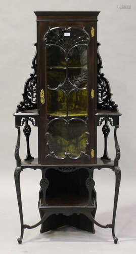 An Edwardian mahogany corner display cabinet with pierced scroll decoration, fitted with a single