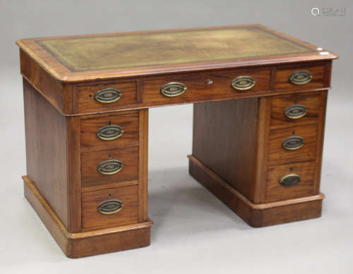 A mid-Victorian mahogany twin pedestal desk, the moulded top inset with gilt-tooled leather above an