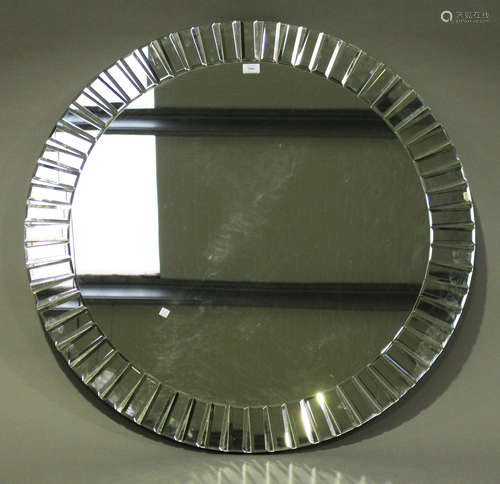 A modern circular wall mirror with bevelled edge, diameter 100cm.Buyer’s Premium 29.4% (including