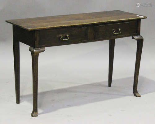 A 20th century oak side table, fitted with two frieze drawers, raised on cabriole legs and shaped