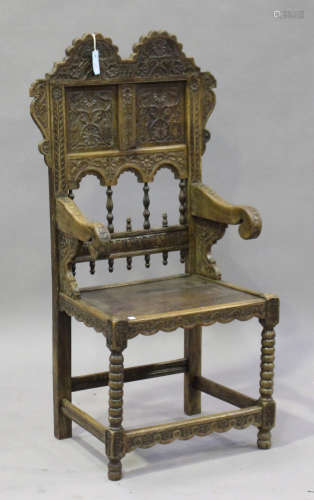 A 20th century Jacobean style oak Wainscot chair, formed from some older elements, the carved back
