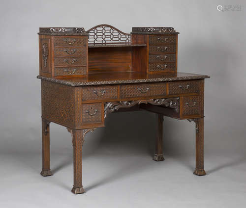 An Edwardian Chinese Chippendale style figured mahogany writing desk with overall pierced and