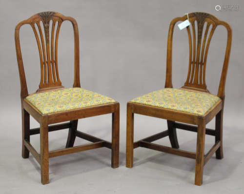 A set of six George III fruitwood pierced splat back dining chairs with drop-in seats, on block