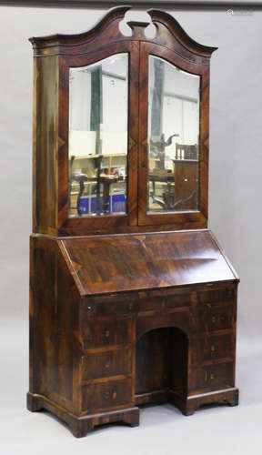 A late 18th century rosewood bureau bookcase with shaped sides, the swan neck pediment above a