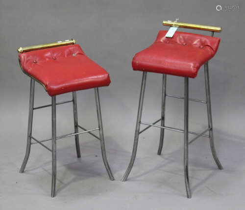 A pair of early 20th century polished steel and brass music chairs with red leatherette seats, on