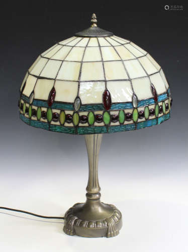 A modern Tiffany style table lamp, the stained and leaded glass shade on a cast metal base, height