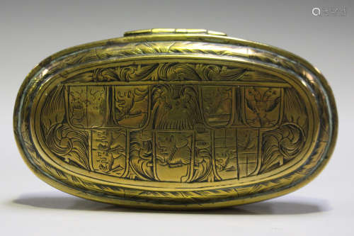 An 18th century Dutch brass tobacco box of oval form, the hinged lid engraved with three circular