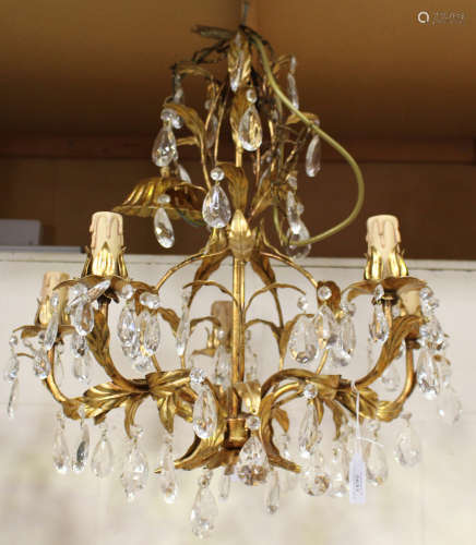 A 20th century gilded wrought metal and glass five-light chandelier of foliate scroll form, height