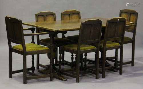 A George V oak refectory table, the rectangular top raised on turned and baluster supports, height