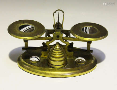 A set of mid-19th century gilt brass and banded agate postal scales, the two pans and oval base