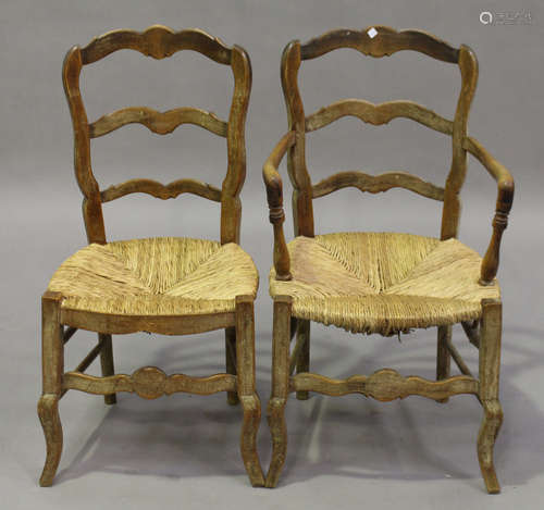 A set of eight 19th century French limed beech ladder back dining chairs, comprising two carvers and