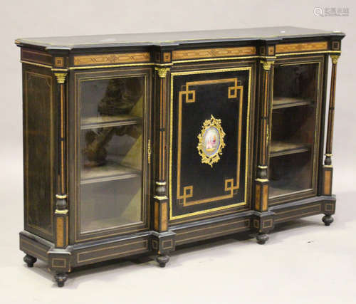 A late Victorian ebonized credenza with burr walnut banding, the central door inset with an oval