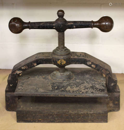 A late 19th century cast iron book press with large brass mounted winding handle, width 50cm.Buyer’s