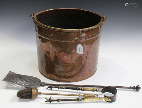 A 19th century patinated copper cylindrical coal bucket with studded seams and swing handle, dated