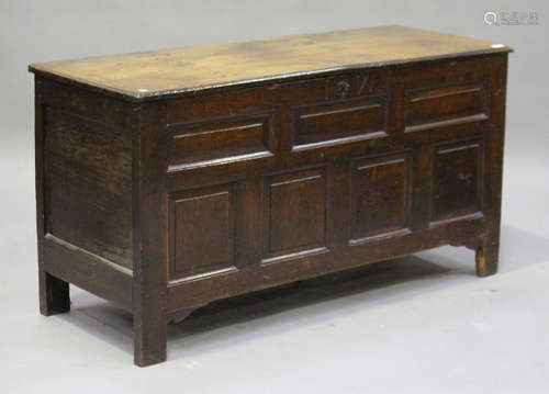 An 18th century oak panelled coffer, the hinged lid above a frieze inscribed with 'I.W', on stile