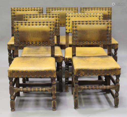 A group of fourteen early 20th century oak framed dining chairs, comprising two sets of six and