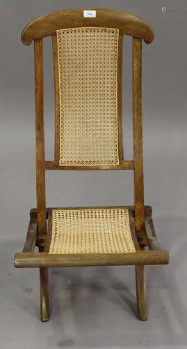 An early 20th century beech framed folding steamer chair with caned seat and back, height 89cm,