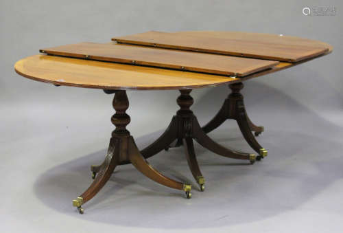 An early 20th century George III style mahogany triple pedestal dining table with boxwood