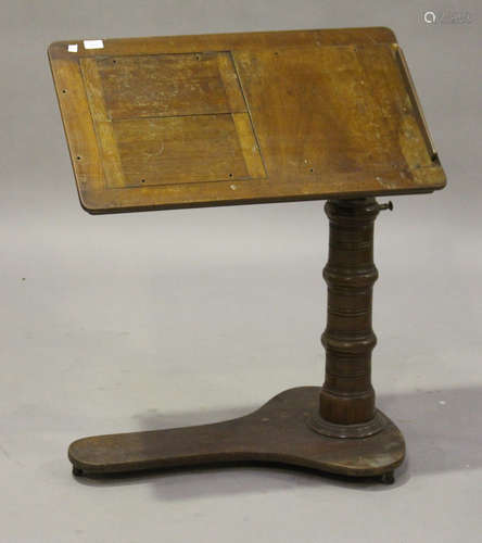 A late Victorian walnut adjustable reading table, the tilting and rising top raised on a turned