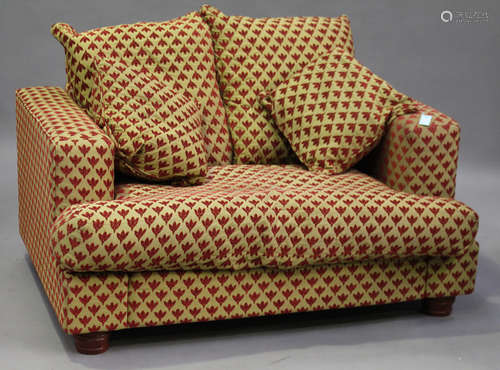 A modern two-seat sofa, upholstered in patterned fabric, on turned feet, height 78cm, width 148cm,