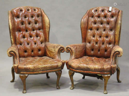 A pair of early/mid-20th century Queen Anne style buttoned red leather wing back armchairs with