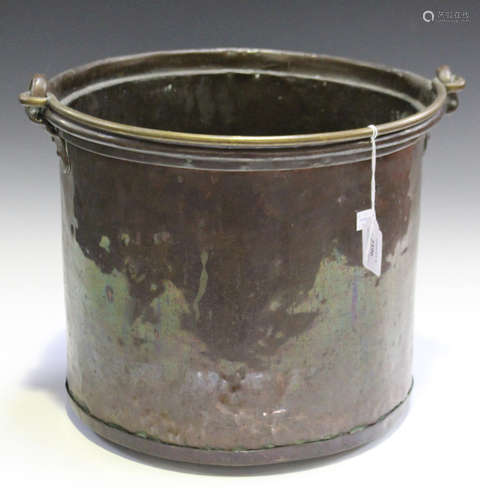 A 19th century patinated copper cylindrical coal bucket with studded seams and swing handle,