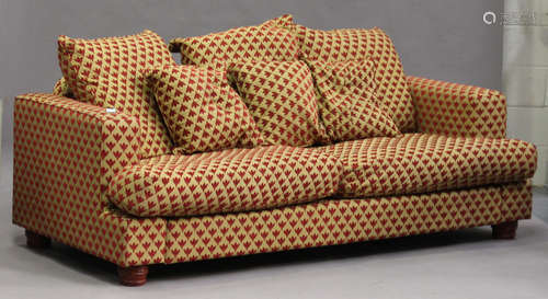 A modern three-seat sofa, upholstered in patterned fabric, on turned feet, height 78cm, width 227cm,