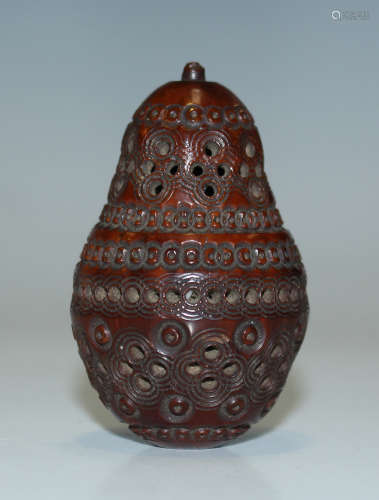 A 19th century carved and pierced coquilla nut box of pear form, length 5.3cm.Buyer’s Premium 29.
