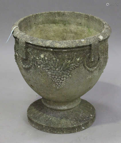 A 20th century cast composition stone garden urn, the ovoid body decorated with bunches of grapes