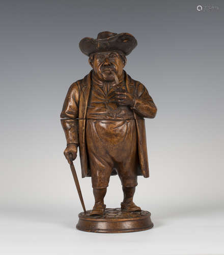 A late 19th century Swiss Black Forest carved softwood figural tobacco jar, finely modelled as a