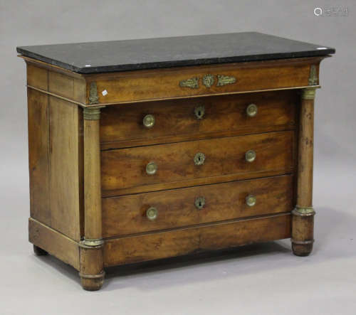 A French Empire mahogany commode with gilt metal mounts, the black marble top above four long