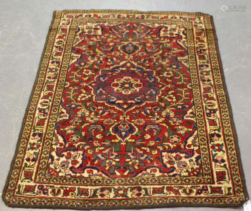 A Bakhtiari rug, North-west Persia, early/mid-20th century, the red field with a flowerhead