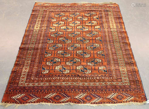 A Tekke rug, West Turkestan, early 20th century, the pale claret field with overall offset rows of