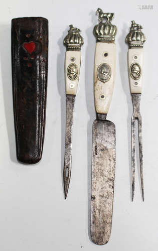 A 19th century Continental bone handled and nickel mounted three-piece trousse cutlery set,