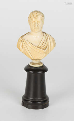 A small mid-19th century carved ivory head and shoulders portrait bust of a gentleman dressed in