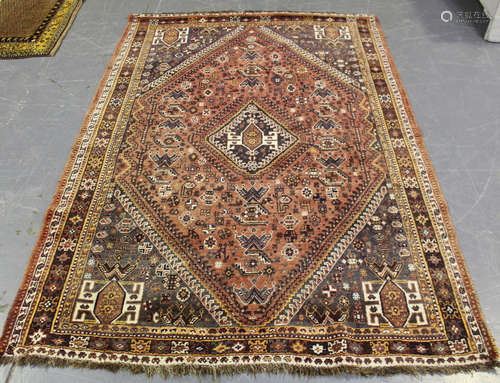 A Shiraz rug, South-west Persia, mid-20th century, the pink field with a lozenge medallion,