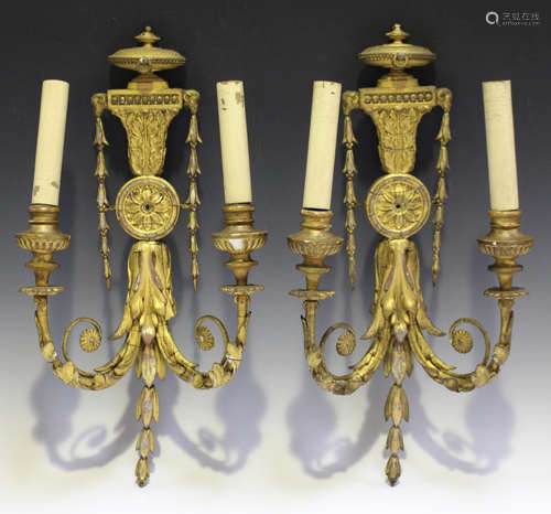 A pair of late Victorian Neoclassical Revival gilt composition twin-light wall sconces, each urn