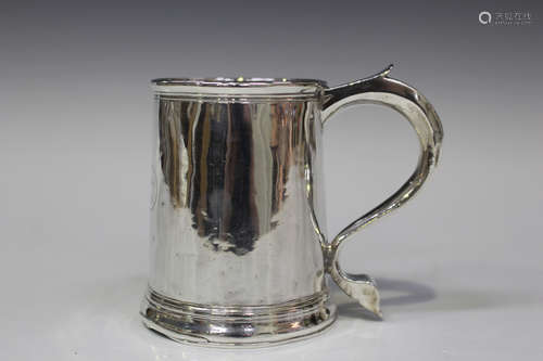 A George I Britannia standard silver tankard, the gently tapered cylindrical body with scroll