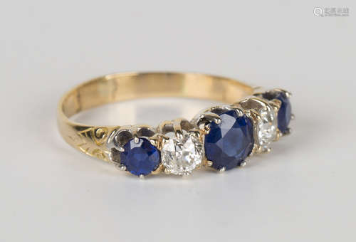 A gold, sapphire and diamond five stone ring, claw set with a row of three circular cut sapphires